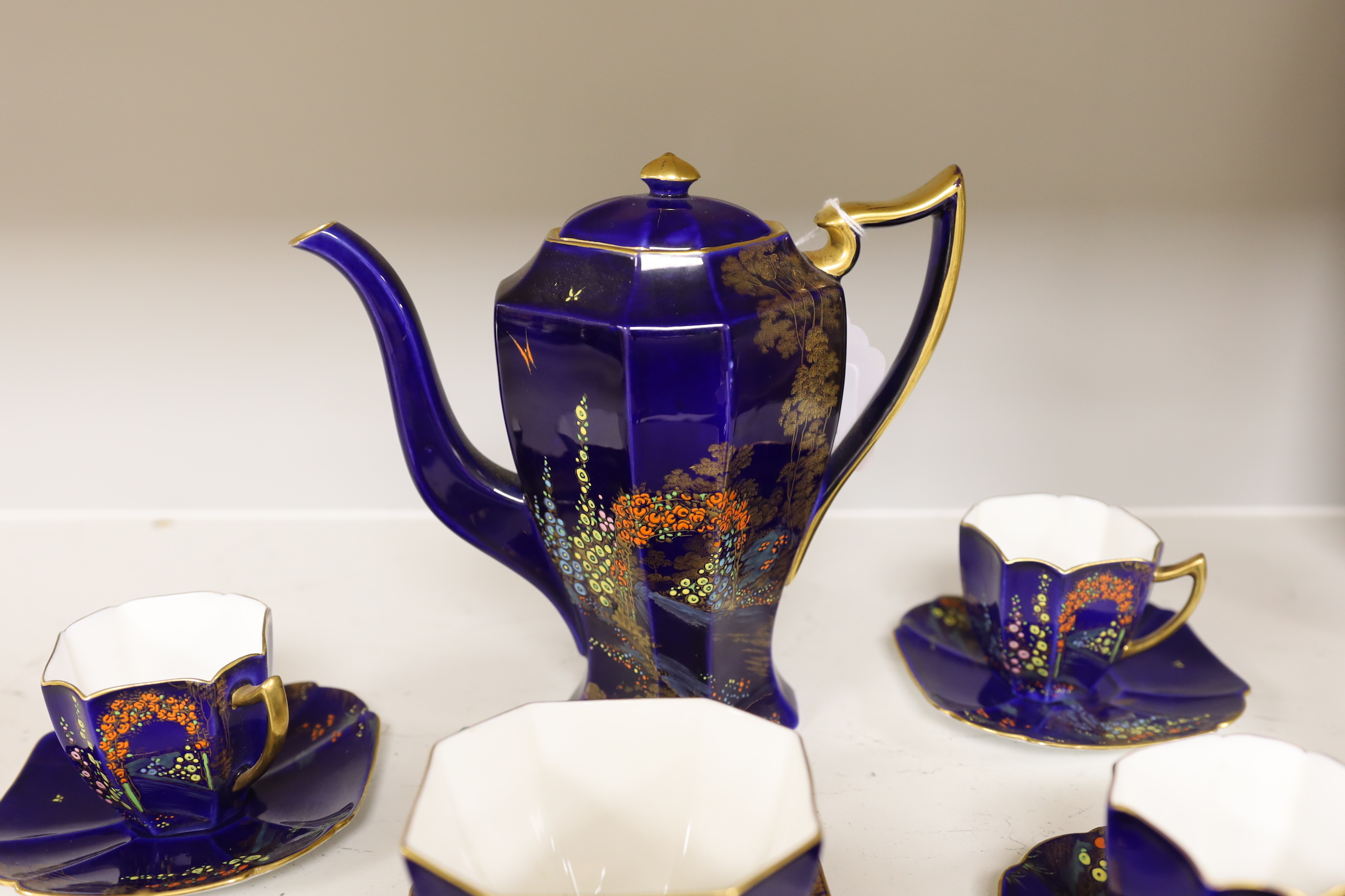 A 1930’s Shelley floral and gilt part coffee set (one cup missing), coffee pot 19cm high